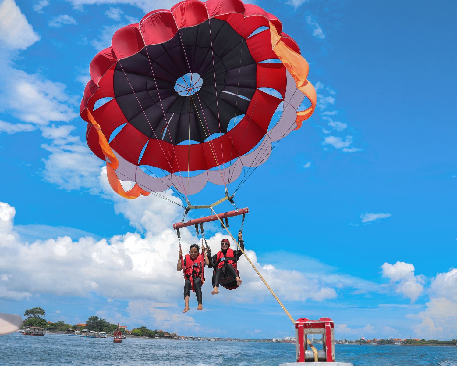 Two persons parasailing
