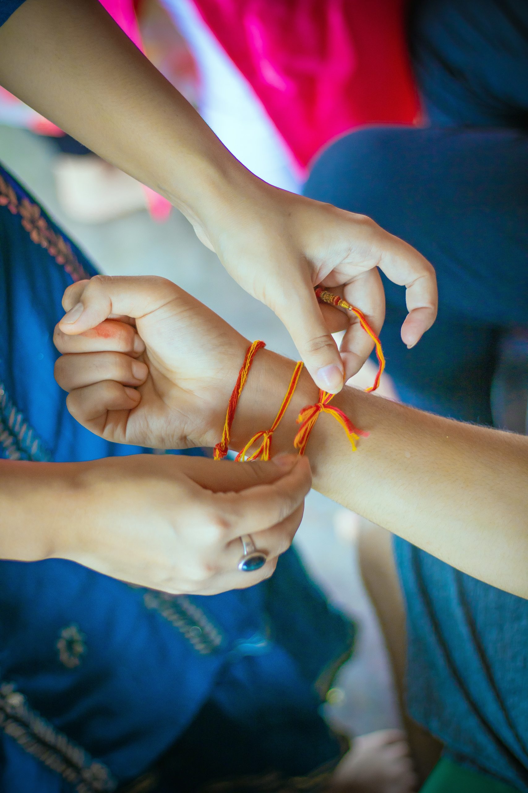 People attaching brazilian bracelet to one another